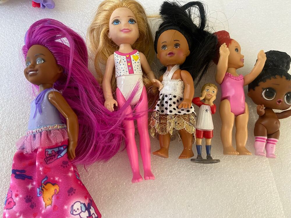 group of small Barbie Club Chelsea dolls and miniature figures in mixed outfits